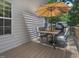 Back deck features a patio set, grill, with view of the green backyard at 221 Antique Lace Way, Holly Springs, NC 27540