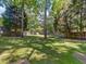 Expansive backyard featuring lush green grass and mature trees at 221 Antique Lace Way, Holly Springs, NC 27540