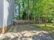 Backyard with fence and trees, adjacent to the home's exterior, offering privacy at 221 Antique Lace Way, Holly Springs, NC 27540