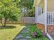 Landscaped backyard with stone pathway leading to the home's entrance at 221 Antique Lace Way, Holly Springs, NC 27540