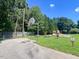Community recreation area with basketball court, playground, picnic tables, and green space at 221 Antique Lace Way, Holly Springs, NC 27540