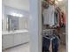 Bathroom with walk in closet, bright vanity and mirror at 221 Antique Lace Way, Holly Springs, NC 27540