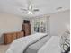 Charming bedroom with window view, dresser, and ceiling fan at 221 Antique Lace Way, Holly Springs, NC 27540