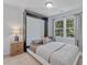 Cozy bedroom featuring a Murphy bed, a window view, and side tables at 221 Antique Lace Way, Holly Springs, NC 27540