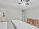 Comfortable bedroom featuring a ceiling fan, dresser, and a view into the ensuite bathroom at 221 Antique Lace Way, Holly Springs, NC 27540