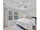 Serene bedroom with a large window, ceiling fan, and neutral decor at 221 Antique Lace Way, Holly Springs, NC 27540