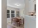 Cozy dining room featuring a wooden table with seating for four, a china cabinet and sunlit windows at 221 Antique Lace Way, Holly Springs, NC 27540
