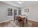 Bright dining area with wooden furniture, natural light, and classic décor at 221 Antique Lace Way, Holly Springs, NC 27540