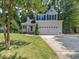 Charming two-story home with a two-car garage, well-manicured lawn, and mature trees at 221 Antique Lace Way, Holly Springs, NC 27540