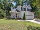 Charming two-story home with a two-car garage, well-manicured lawn, and mature trees at 221 Antique Lace Way, Holly Springs, NC 27540