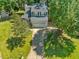 Charming two-story home boasts a well-manicured lawn, mature trees, and an attached two-car garage at 221 Antique Lace Way, Holly Springs, NC 27540