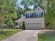 Charming two-story home with a two-car garage, well-manicured lawn, and mature trees at 221 Antique Lace Way, Holly Springs, NC 27540