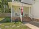 Cozy front porch with brick steps and white railings, perfect for relaxing outdoors at 221 Antique Lace Way, Holly Springs, NC 27540