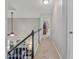 Upstairs hallway showcasing neutral carpeting and an open view of the living area at 221 Antique Lace Way, Holly Springs, NC 27540