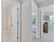 Bright hallway view showcasing the bathroom and bedroom through open doorways at 221 Antique Lace Way, Holly Springs, NC 27540