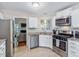 Modern kitchen featuring stainless steel appliances, granite countertops, and ample cabinet space at 221 Antique Lace Way, Holly Springs, NC 27540