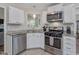 Well-equipped kitchen featuring stainless steel appliances, and granite countertops at 221 Antique Lace Way, Holly Springs, NC 27540