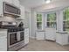 Bright kitchen with stainless steel appliances, and breakfast nook at 221 Antique Lace Way, Holly Springs, NC 27540