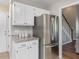 Bright kitchen with stainless steel refrigerator and plenty of cabinet space at 221 Antique Lace Way, Holly Springs, NC 27540