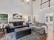 Bright living room with high ceilings, neutral furniture, and a staircase leading to the second floor at 221 Antique Lace Way, Holly Springs, NC 27540