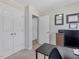 Well-lit office with desk, storage, and view of other rooms through the open door at 221 Antique Lace Way, Holly Springs, NC 27540