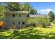 Backyard view with Adirondack chairs on patio and lush lawn at 2317 Bertie Dr, Raleigh, NC 27610