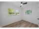 Bedroom features hardwood floors, large window, and ceiling fan at 2317 Bertie Dr, Raleigh, NC 27610
