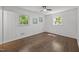 Cozy bedroom with beautiful hardwood floors, ceiling fan and many windows at 2317 Bertie Dr, Raleigh, NC 27610