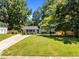 Charming home featuring a lush front lawn, well-maintained landscaping, and a paved driveway at 2317 Bertie Dr, Raleigh, NC 27610