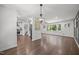 Open-concept living space with hardwood floors, modern lighting, and convenient access to kitchen and staircase at 2317 Bertie Dr, Raleigh, NC 27610