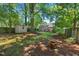 View of the backyard showing shed, brick fire pit and deck at 2504 State St, Durham, NC 27704