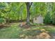 Backyard view featuring a storage shed and comfortable hammock swing at 2504 State St, Durham, NC 27704