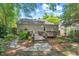 Cozy backyard with wooden deck, table, string lights, and lush landscaping at 2504 State St, Durham, NC 27704