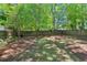 Spacious backyard with a well-maintained lawn and brick fire pit, perfect for outdoor entertaining at 2504 State St, Durham, NC 27704