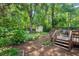 Secluded backyard with mature trees, deck, and storage shed at 2504 State St, Durham, NC 27704