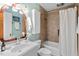 Charming bathroom featuring a tiled shower, vanity, and vintage lighting at 2504 State St, Durham, NC 27704