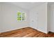 Bright bedroom with hardwood floors, a large window, and a closet at 2504 State St, Durham, NC 27704