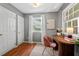 Cozy bedroom features hardwood floors, natural light from the window, and a pink chair at 2504 State St, Durham, NC 27704