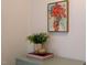 Close-up of decor featuring a painting, plant, and books on top of a cabinet at 2504 State St, Durham, NC 27704