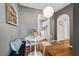 Charming dining area with round table, stylish chairs, and view into the kitchen at 2504 State St, Durham, NC 27704