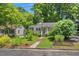 Beautiful home with mature trees and landscaping, creating a serene and inviting atmosphere at 2504 State St, Durham, NC 27704