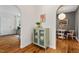 Hallway with hardwood floors, stylish cabinet, and arched doorways leading to other rooms at 2504 State St, Durham, NC 27704