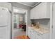 Kitchen featuring white cabinets, granite countertops, and a view of the office at 2504 State St, Durham, NC 27704