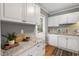 Charming kitchen showcasing white cabinets, granite countertops, and stainless steel dishwasher at 2504 State St, Durham, NC 27704