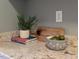 Close up of granite countertops, decor, and a plant bringing life into the kitchen at 2504 State St, Durham, NC 27704