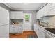 Bright kitchen with white cabinets, granite countertops, and a view of the backyard at 2504 State St, Durham, NC 27704