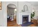 Bright living room featuring a fireplace, arched doorways, and hardwood floors at 2504 State St, Durham, NC 27704