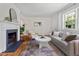 Comfortable living room with fireplace, hardwood floors and a cozy seating arrangement with natural light at 2504 State St, Durham, NC 27704