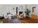 Inviting living room with fireplace, hardwood floors and arched doorways leading to other rooms at 2504 State St, Durham, NC 27704