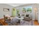 Cozy living room with neutral tones, hardwood floors and natural light from a large window at 2504 State St, Durham, NC 27704